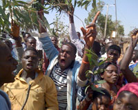 An angry crowd gathers in the aftermath of armed raids on student quarters at Jos Federal College in March (Photos: CSW)