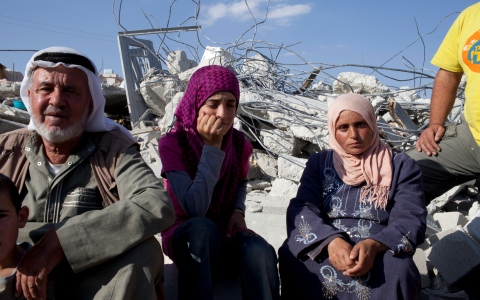 Rasmiya Abu Arem (right), her daughter and her father-in-law lie amid the rubble of their home in Ad Deirat, South Hebron Hills, demolished a few hours before. Credit: Christian Aid/Sarah Malian Rasmiya Abu Arem (right), her daughter and her father-in-law lie amid the rubble of their home in Ad Deirat, South Hebron Hills, demolished a few hours before. Credit: Christian Aid/Sarah Malian