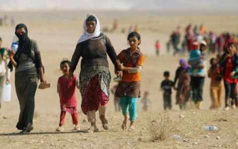 Yezidi women flee ISIS violence. Photo: Reuters