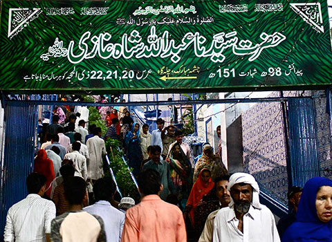 Sign at the entrance to Hazrat Sayyadanna Abdullah Shah Ghazi’s shrine in Karachi. The yellow arrow indicates the direction of the pond where the Saint would meditate Sign at the entrance to Hazrat Sayyadanna Abdullah Shah Ghazi’s shrine in Karachi. The yellow arrow indicates the direction of the pond where the Saint would meditate